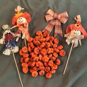 Decorative fall lot. 3 scarecrows on sticks. 1 bow. 66 mini pumpkins.
